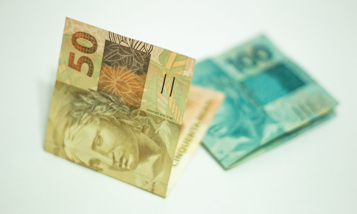 Notas de 50 e 100 reais, valor que cai na primeira parcela do 13º