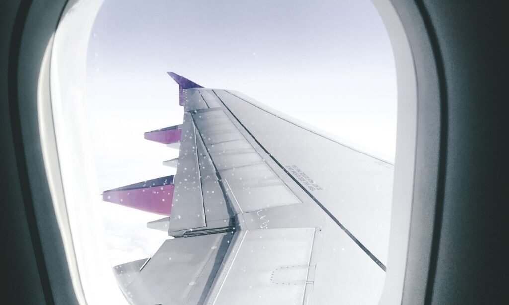 Asa de avião vista pela janela, tema de quem pensa em vender milhas